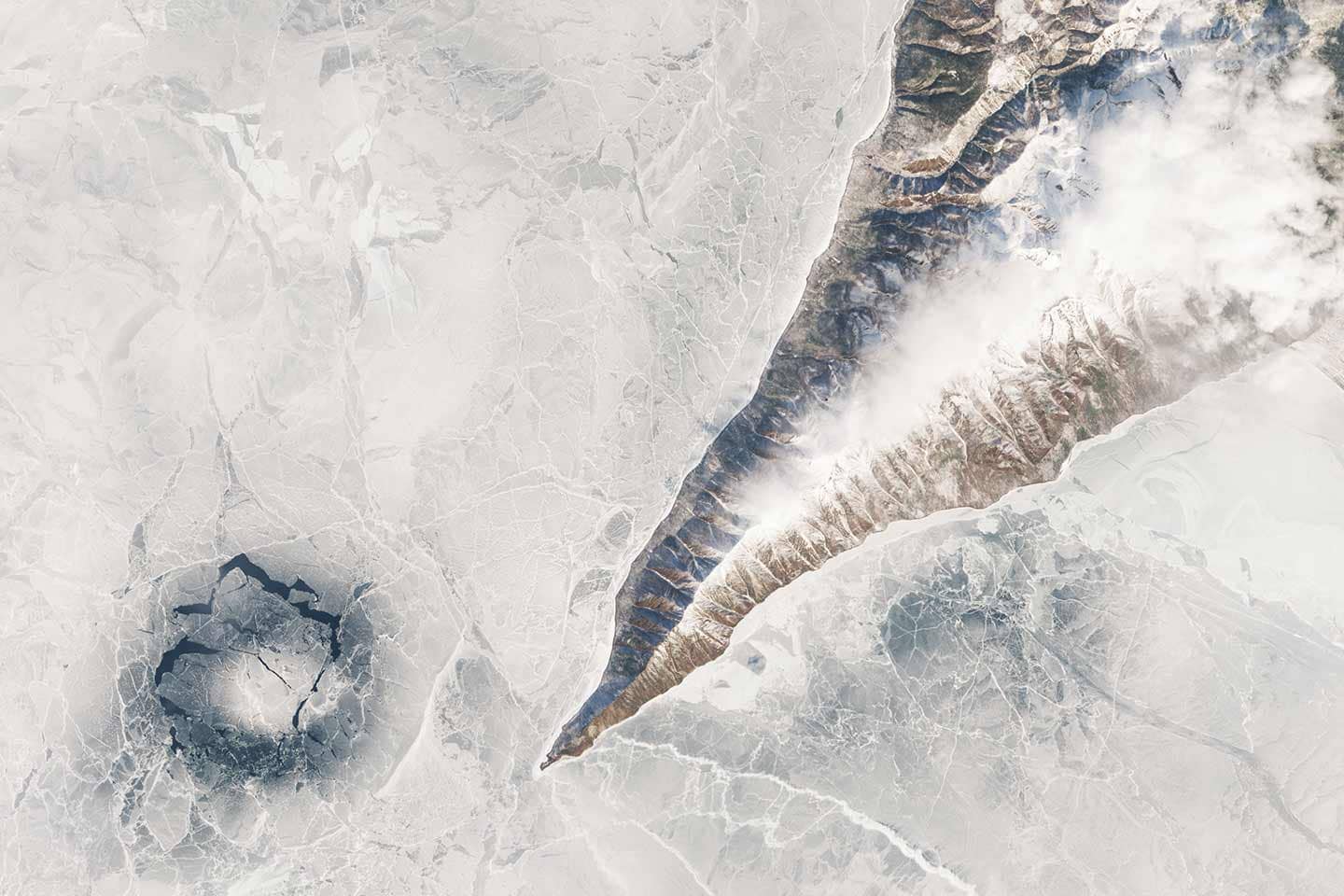 Dark blue ice ring formed off the Nizhneye Izgolovye Cape, at Lake Baikal.